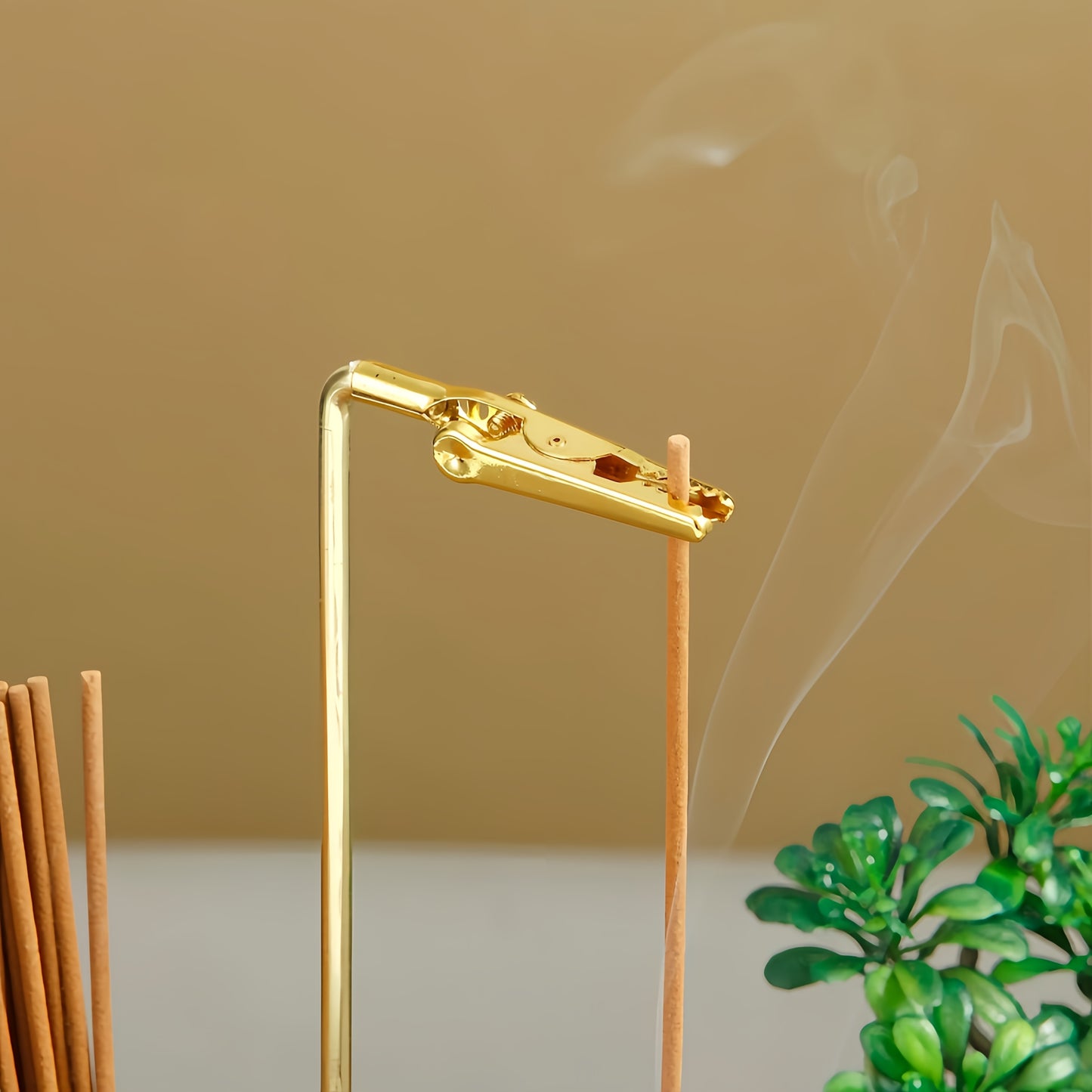 Nutshell anti-ash incense holder with storage featuring a sleek gold design and a minimalist style