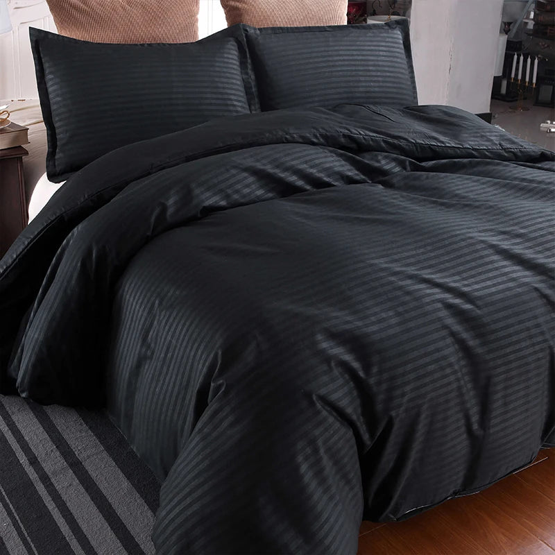 Nutshell black satin duvet cover set with striped pattern on bed with matching pillowcases
