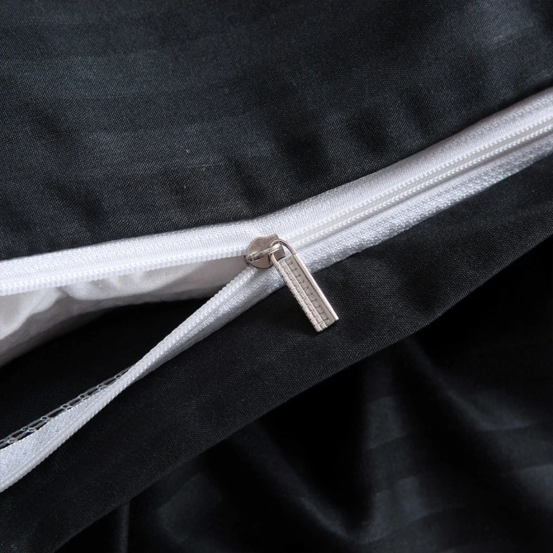 Close-up of zipper detail on Nutshell black satin duvet cover set showing smooth fabric texture