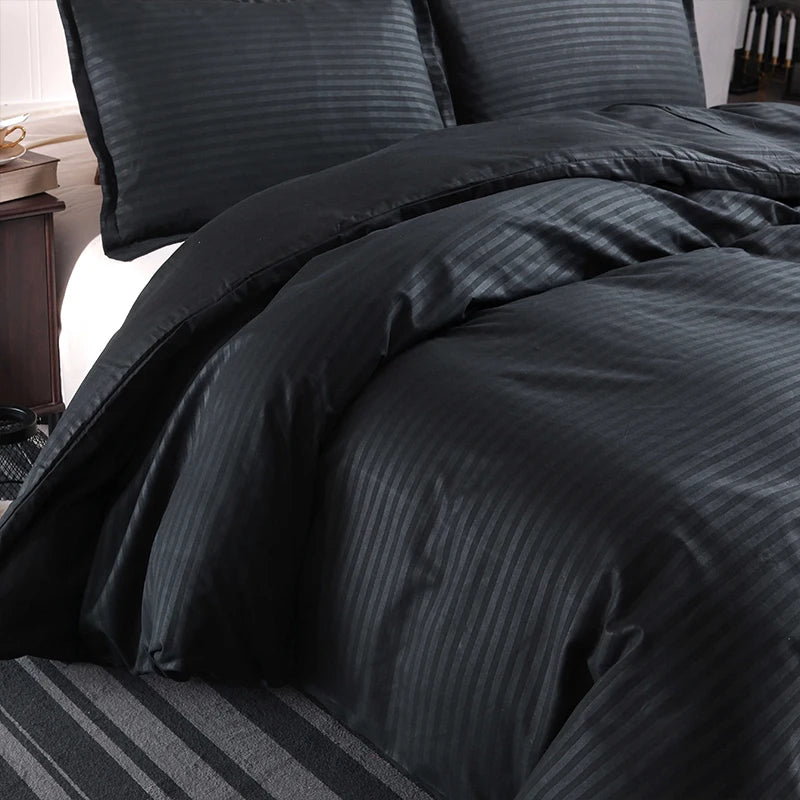 Nutshell black satin duvet cover set with subtle stripe pattern on a neatly made bed