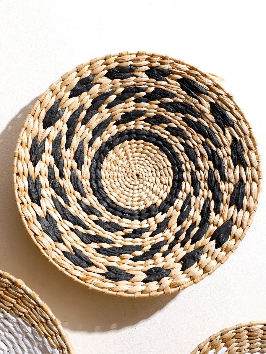 Nutshell round woven bohemian wall decor in natural and black colors with spiral pattern