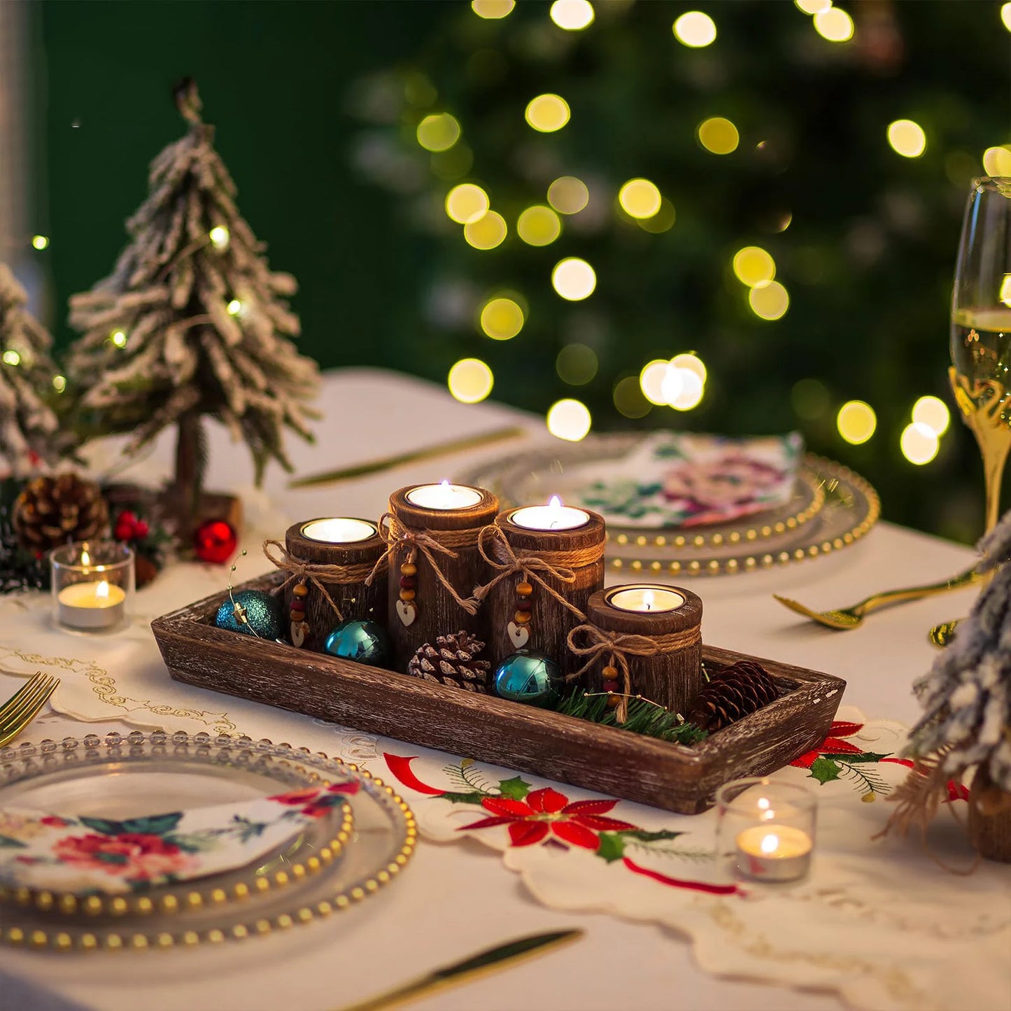 Boho wooden tray candle centerpiece with pinecones and blue ornaments on festive dining table