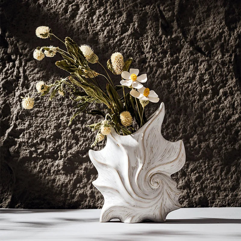 CAPIRON Ceramic Conch Vase by Nutshell with dried flowers against textured dark background
