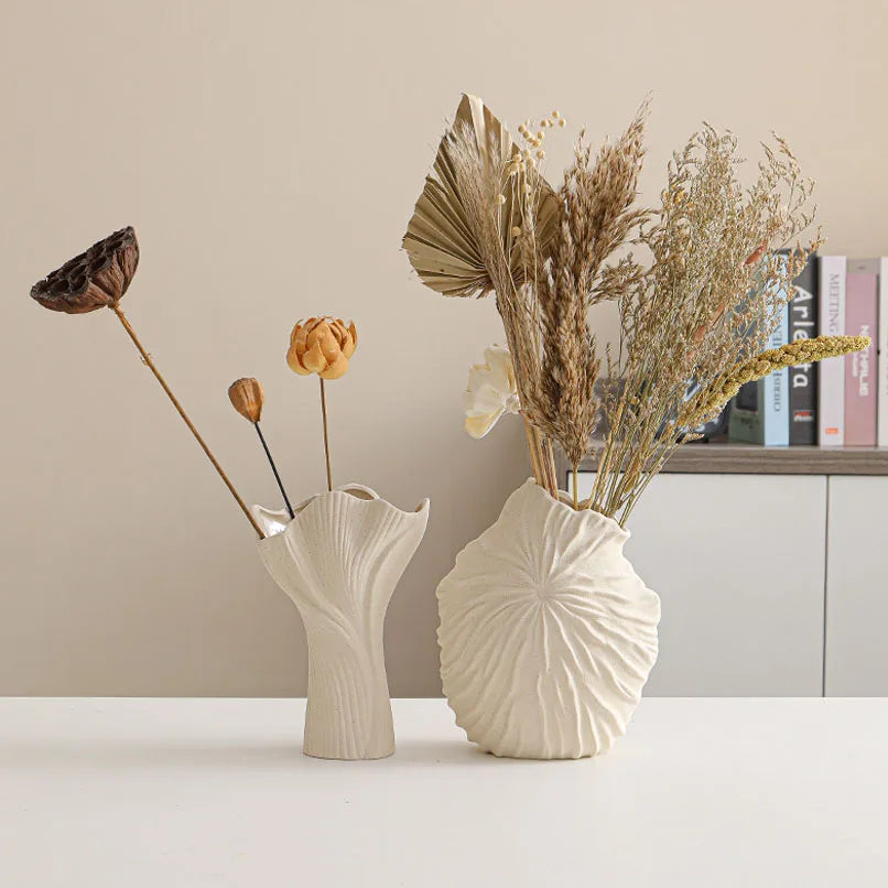 Nutshell ceramic conch design vase in white with dried flowers on a white table