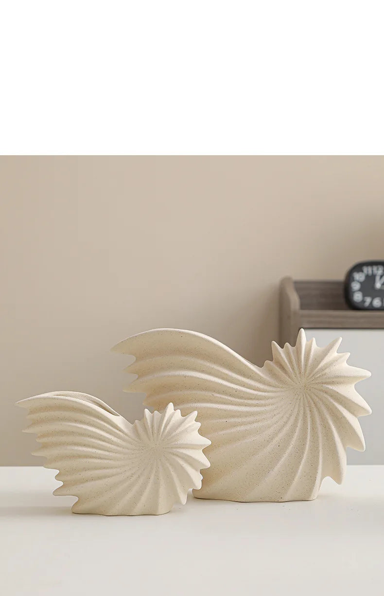 Nutshell ceramic conch design vase set in beige with textured spiral shapes on white surface