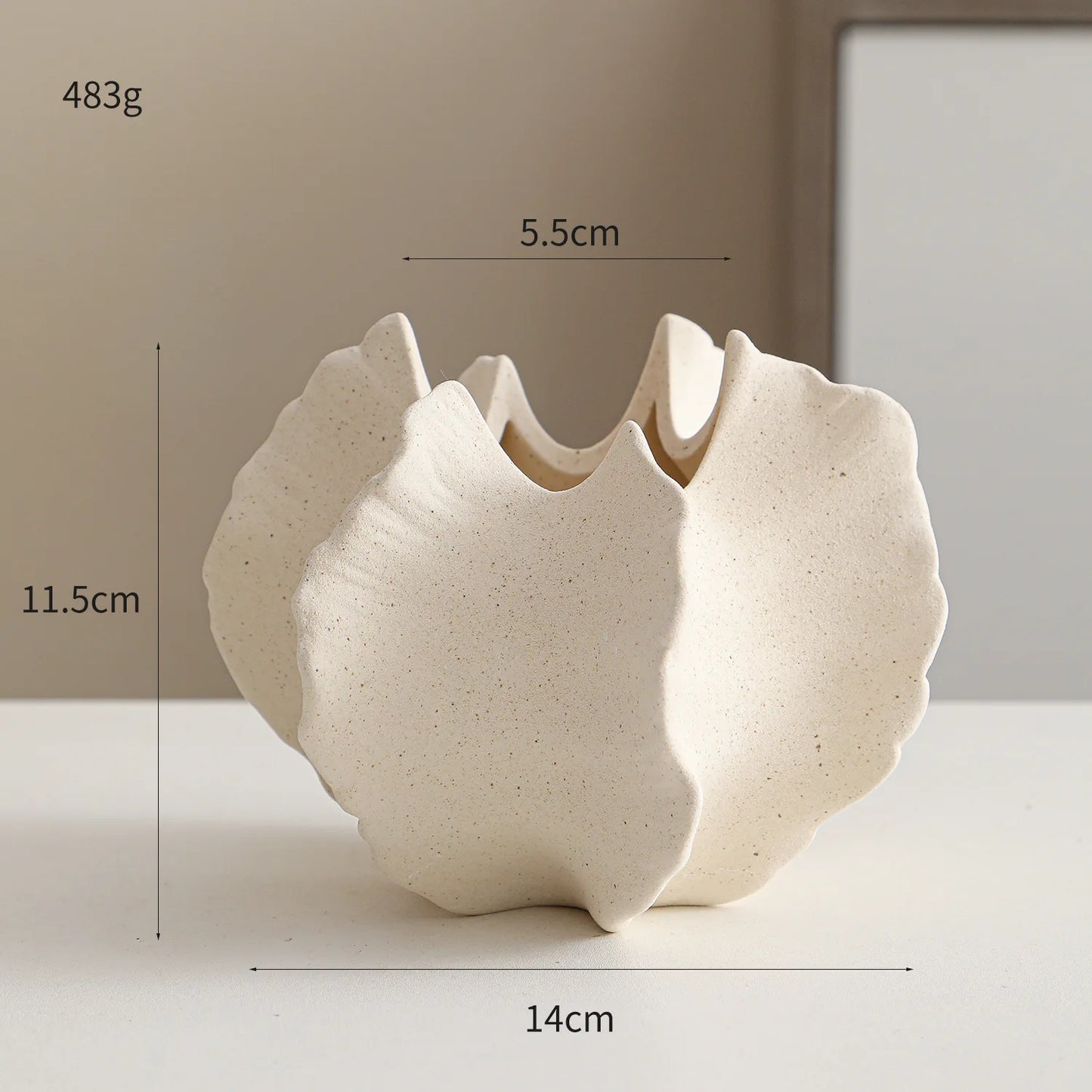 Nutshell ceramic conch design vase in beige with textured surface and unique shell shape