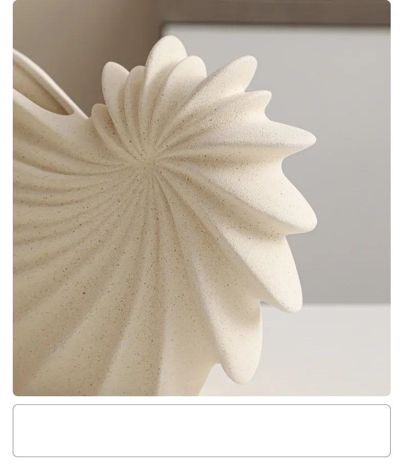 Nutshell ceramic conch design vase in off-white with textured spiral shell pattern detail
