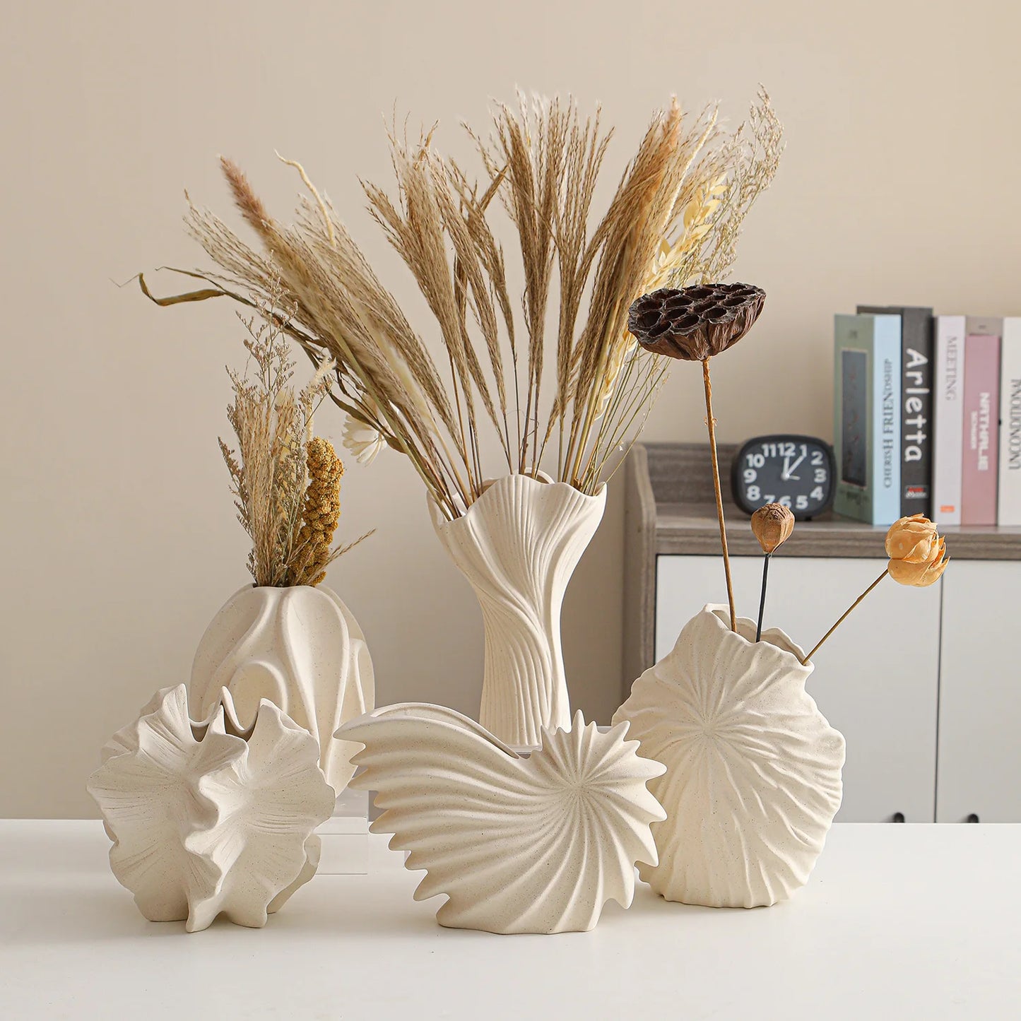 Nutshell ceramic conch design vase collection with textured seashell shapes and dried floral arrangements