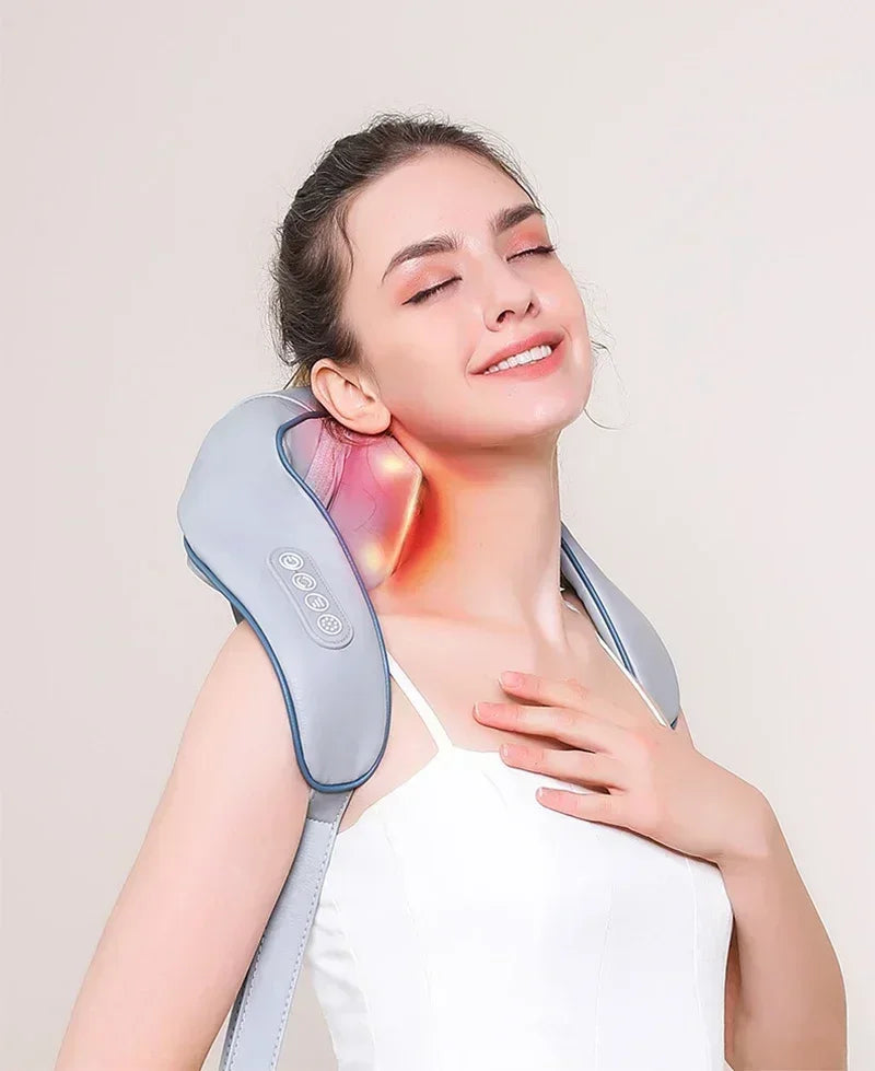 Nutshell 3D kneading neck massager with heat on woman shoulders glowing red while she relaxes with hands free straps