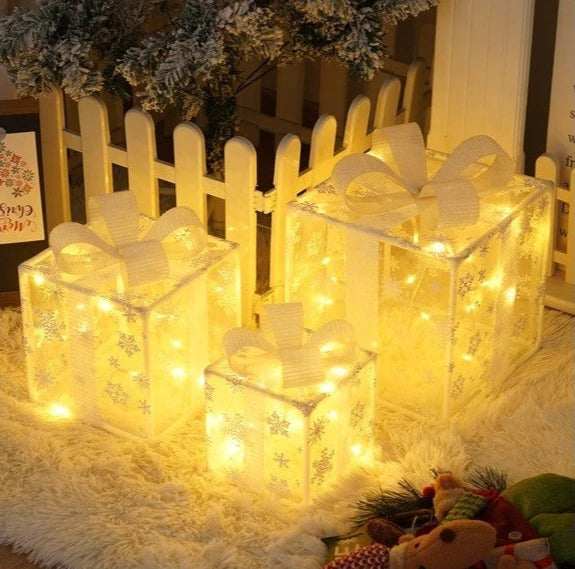 Set of three Christmas light up gift boxes with glowing lights and decorative bows for holiday decor