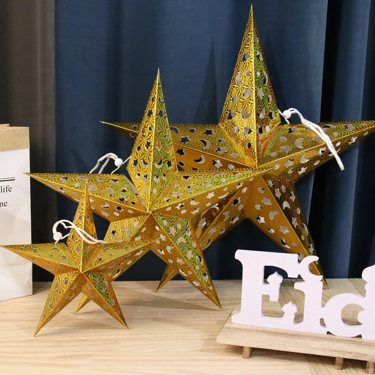 Gold Christmas star paper lanterns in various sizes, perfect for festive home decor