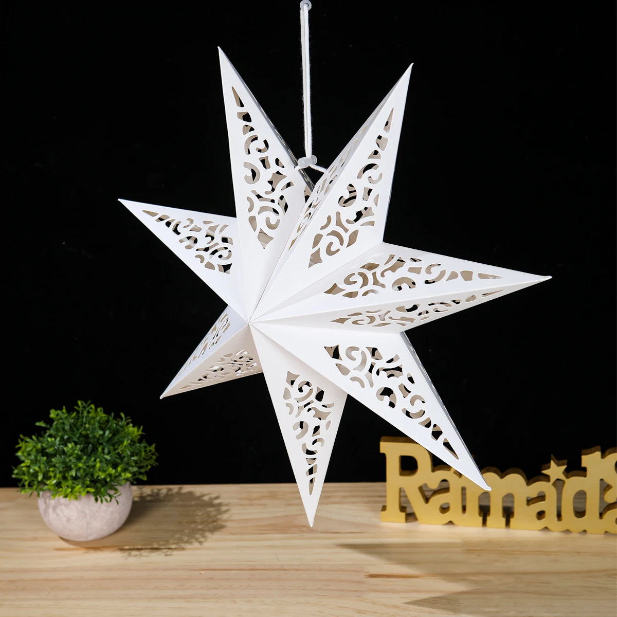 Nutshell Christmas star paper lantern in white hanging decor with intricate cut-out designs
