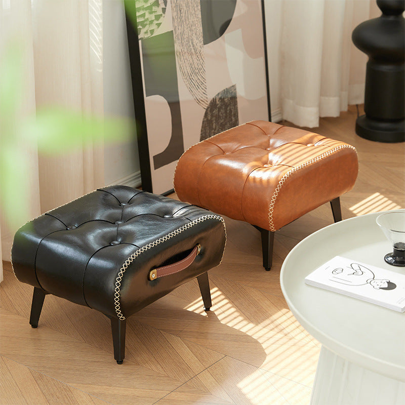 Nutshell comfortable faux leather footrest in black and brown, perfect for stylish living spaces