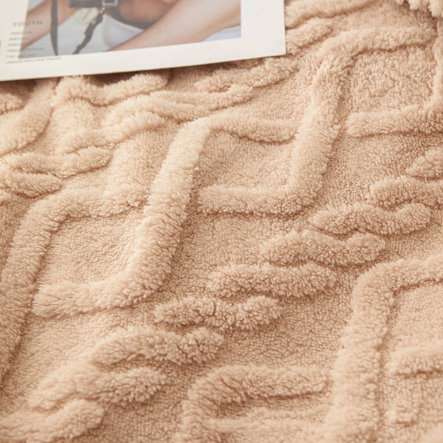 Nutshell beige plush warm sofa throw blanket with raised geometric texture shown on couch