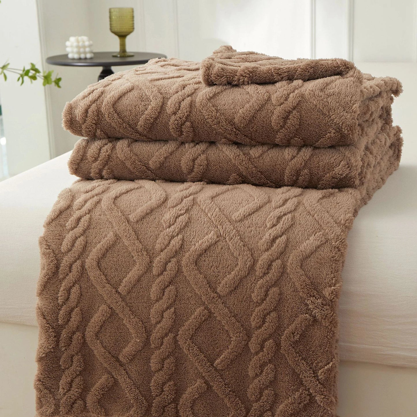 Nutshell brown plush cable knit warm sofa throw blanket draped on sofa folded for cozy living room use