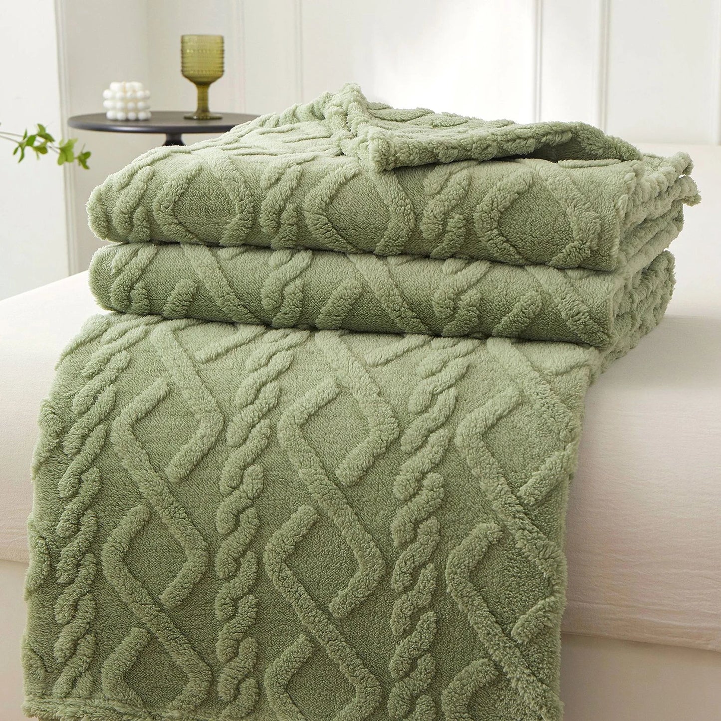 Nutshell sage green plush cable knit warm sofa throw blanket folded on sofa for cozy living room
