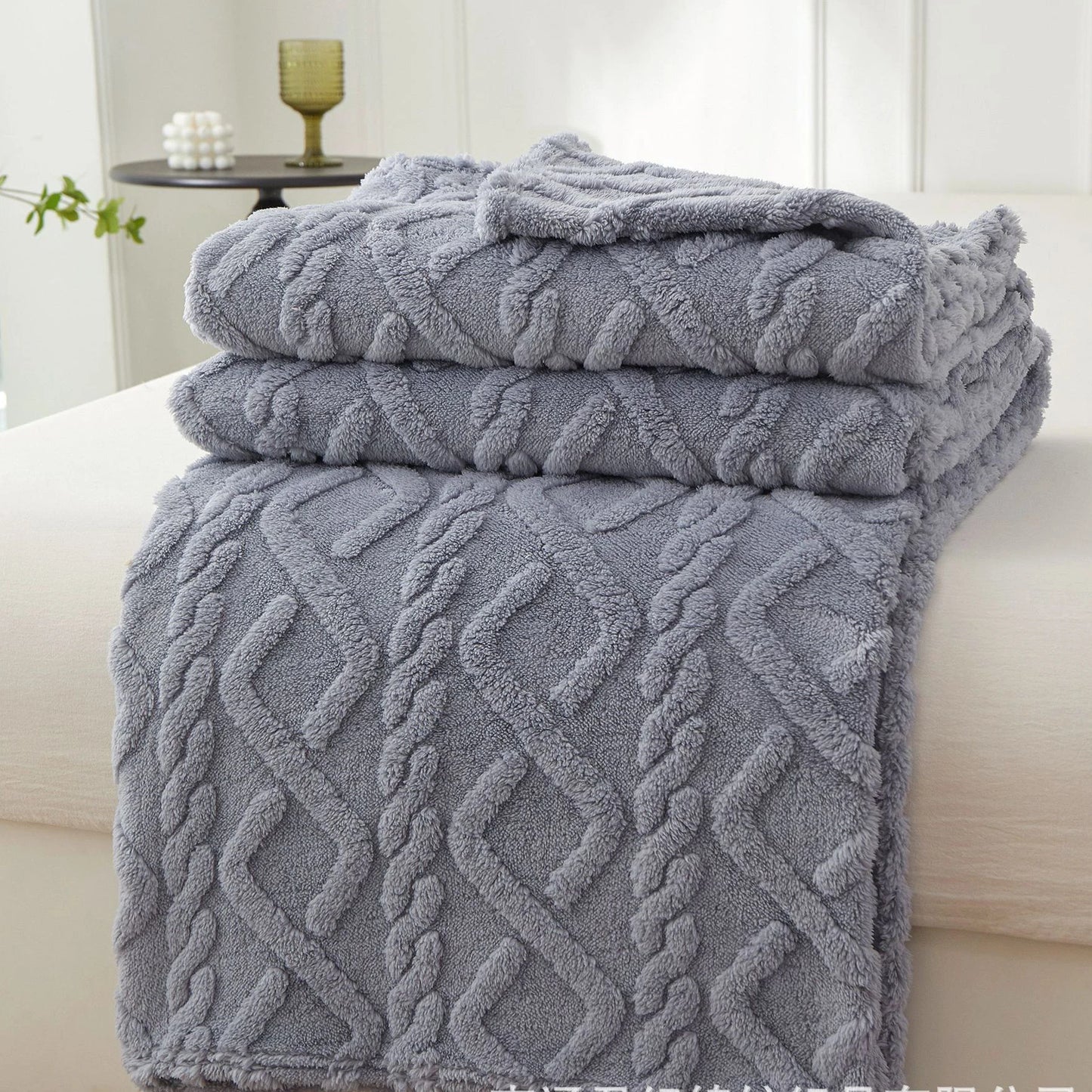 Nutshell gray cable knit textured plush warm sofa throw blanket folded on bed for cozy decor