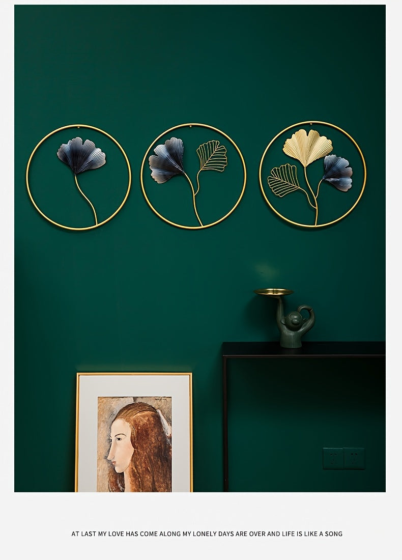 European style wall art featuring three circular floral designs in gold frames against a green wall