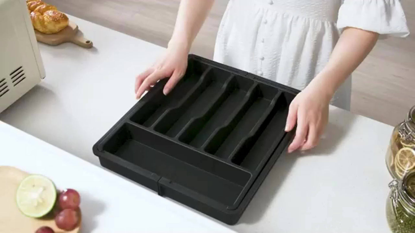 Nutshell expandable cutlery tray in use, featuring multiple compartments for organizing kitchen utensils