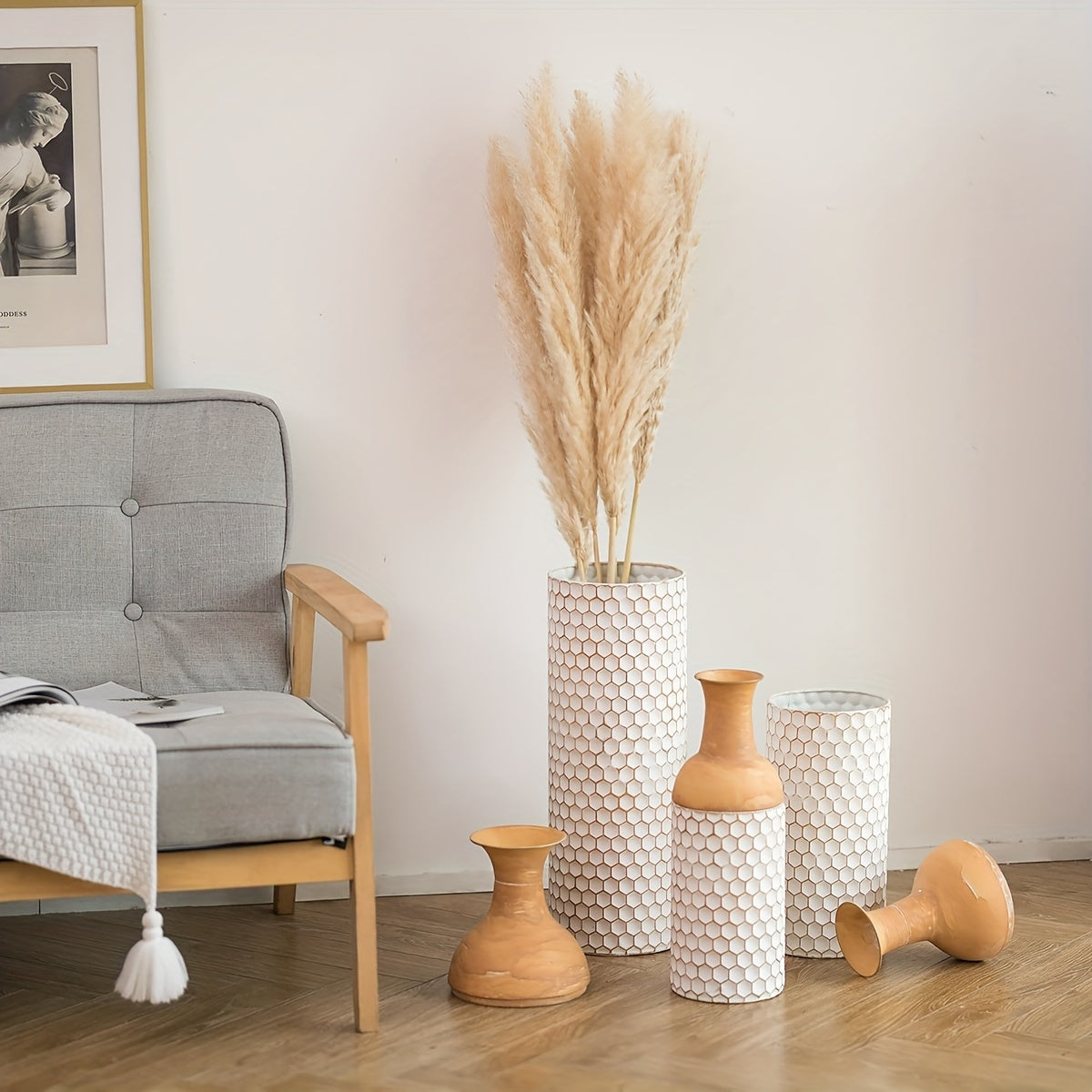 Stylish arrangement of extra large metal floor vases in a cozy living room setting