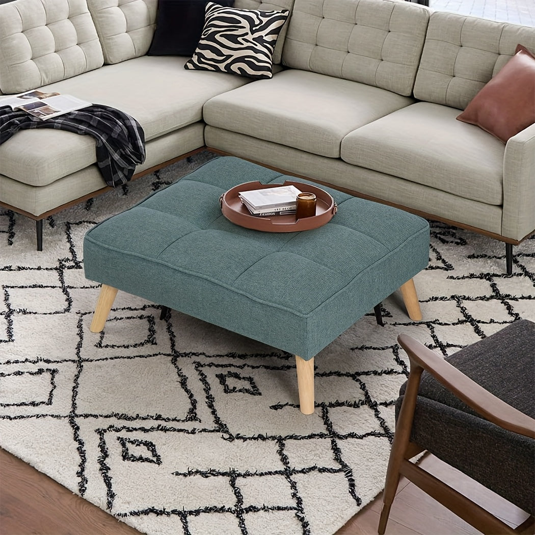 Nutshell tufted linen footstool in teal with wooden legs, perfect for living room decor