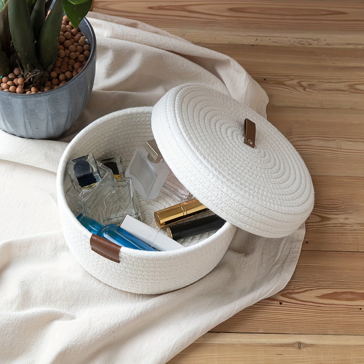 Functional Woven Basket with Lid displaying organized beauty products on a soft fabric surface