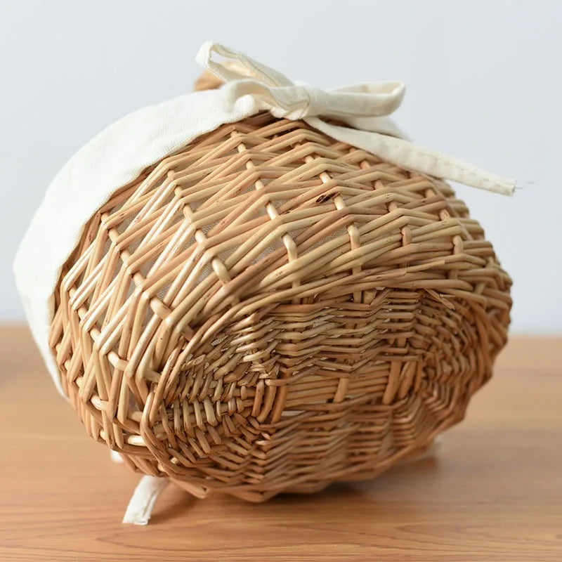Nutshell handcrafted wicker basket with white fabric liner on wooden surface