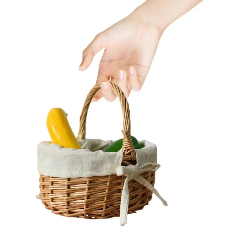Hand holding a handcrafted wicker basket by Nutshell with cloth lining and fresh vegetables inside