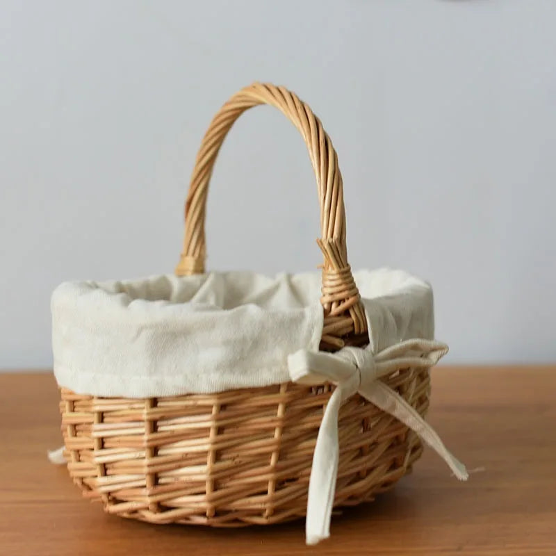 Nutshell handcrafted wicker basket with cloth lining and tied bow handle on wooden table