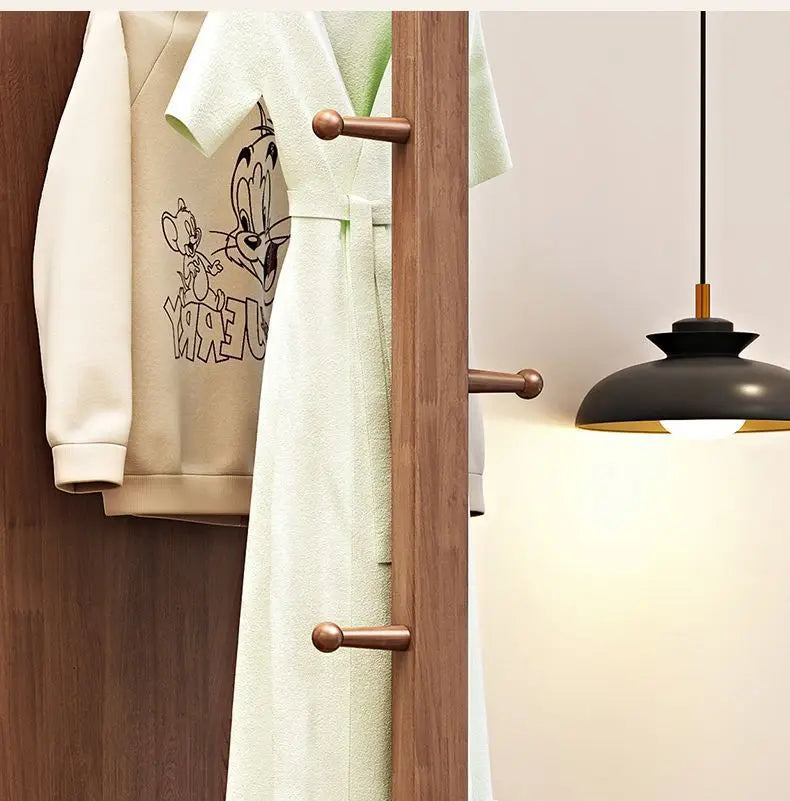Nutshell Rotating Full Length Mirror with wooden peg hooks showing robes and lamp in modern entryway