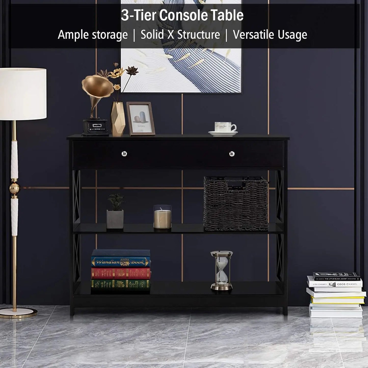 Nutshell 3-Tier Console Table in black with drawer and X frame shelves styled with decor books and lamp