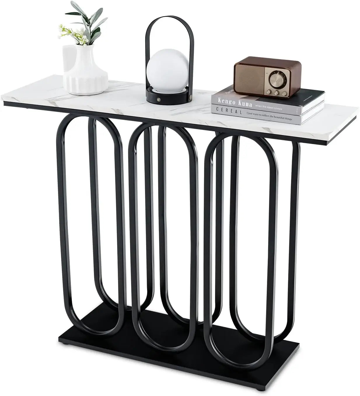Nutshell faux marble console table with white marble top and black sculptural looped metal base styled with vase lamp and books