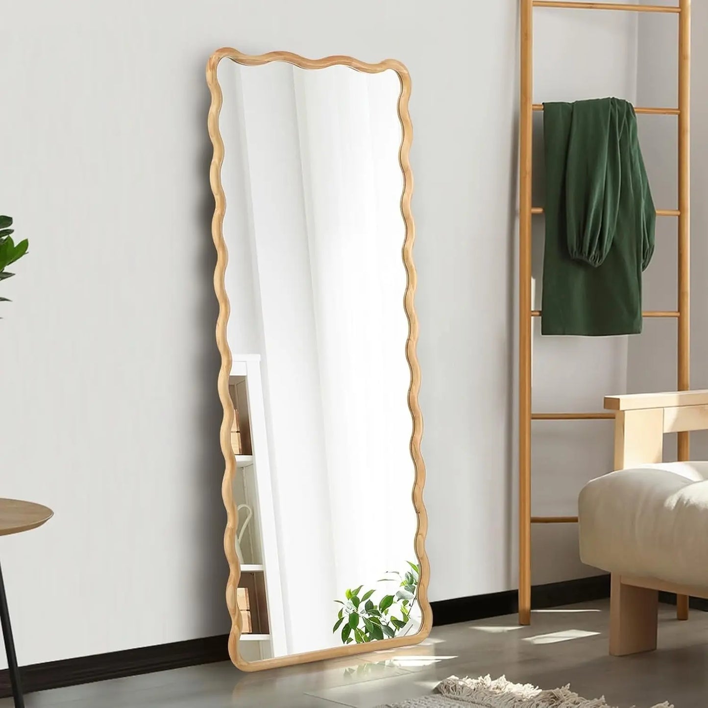 Nutshell rectangular wooden frame mirror with scalloped edges leaning against wall in bedroom