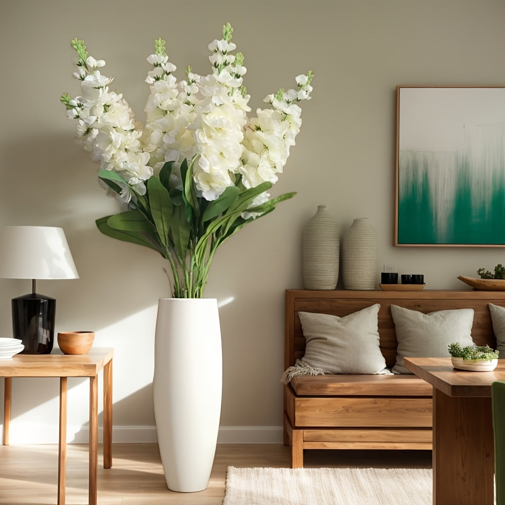 Large outdoor artificial delphinium in a modern white vase, adding elegance to the living room decor