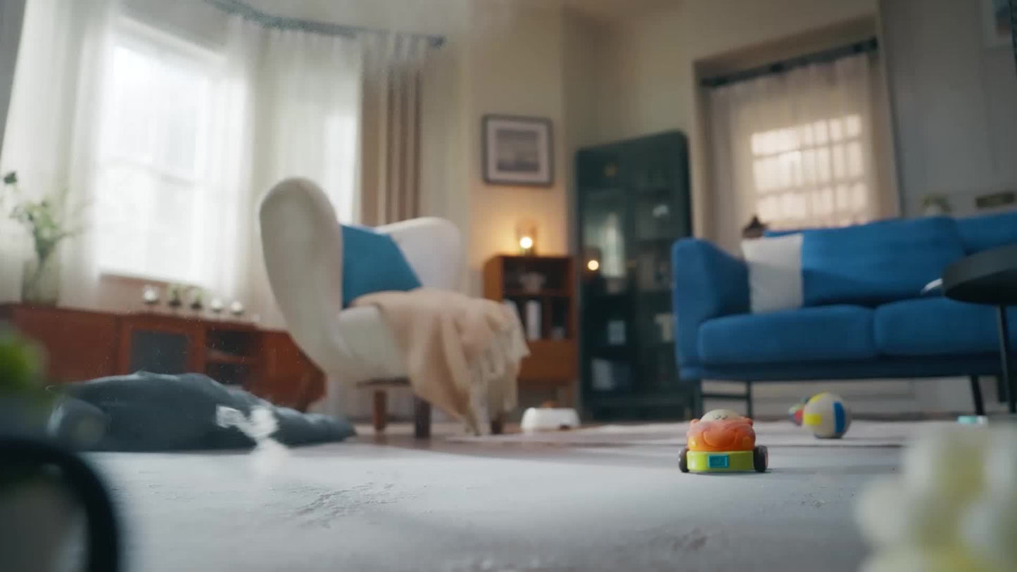 Nutshell robot vacuum and mop combo cleaning a light carpet in a cozy living room