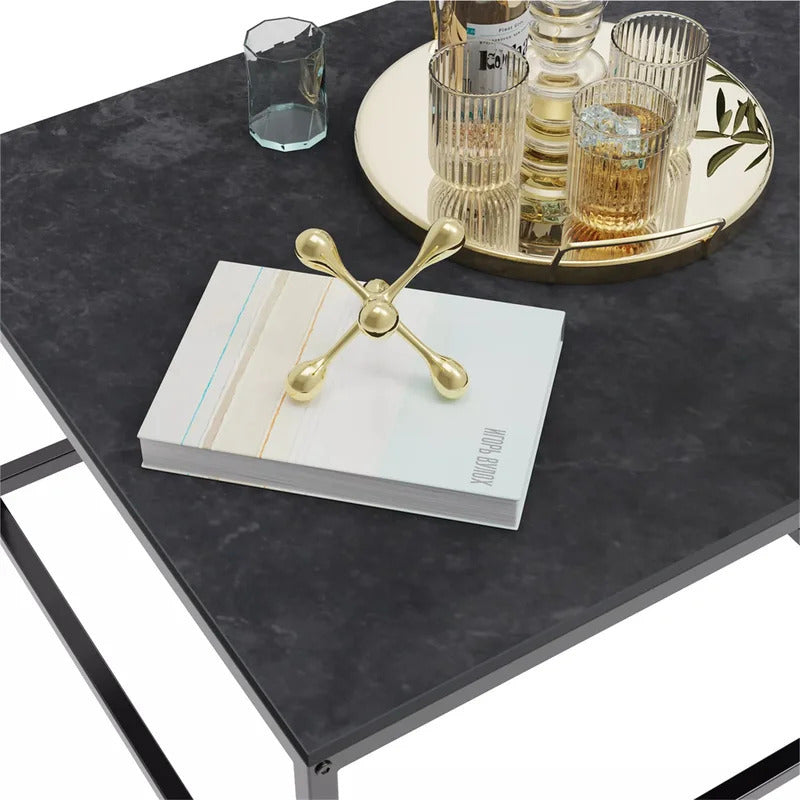 Nutshell Rectangle Nesting Coffee Table Set with black stone top and metal frame holding a book and decorative tray