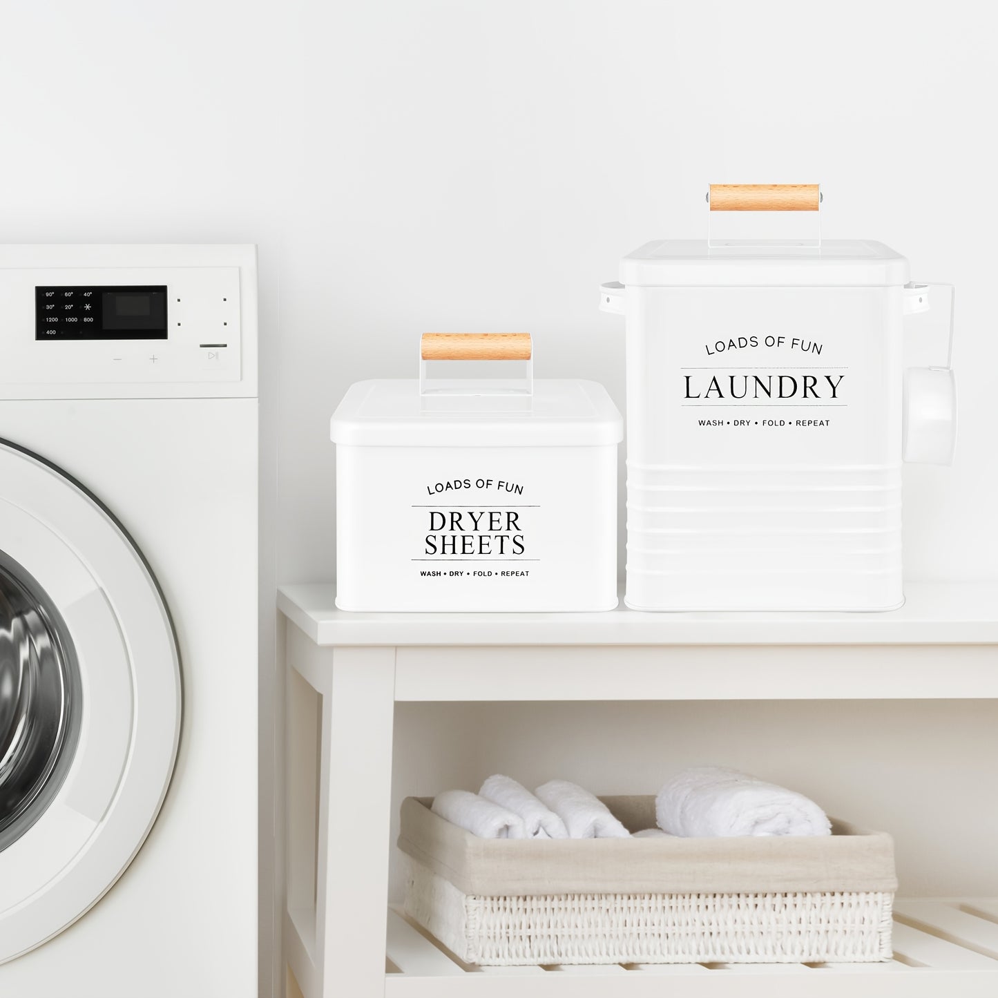 Nutshell modern farmhouse laundry storage containers in white with wooden handles next to a washing machine