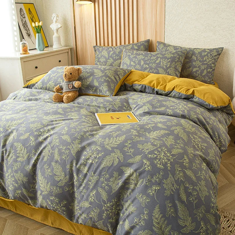 Nutshell modern floral quilt cover with green leaf pattern and mustard yellow accents on bed