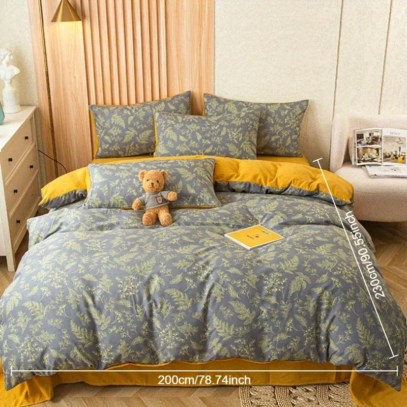 Nutshell modern floral quilt cover in gray and yellow on bed with matching pillows and teddy bear