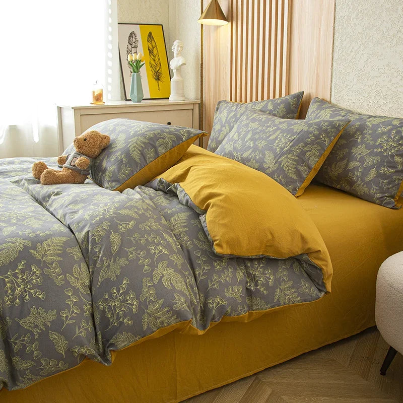 Nutshell modern floral quilt cover in gray and yellow with botanical print on bed with pillows and teddy bear