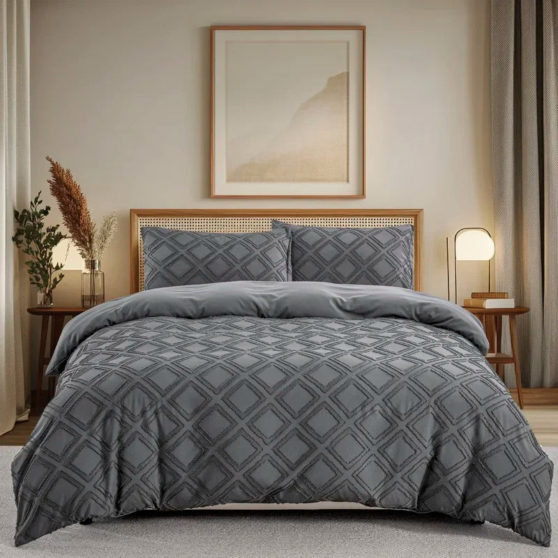 Modern geometric duvet cover in gray with diamond pattern on bed with matching pillowcases