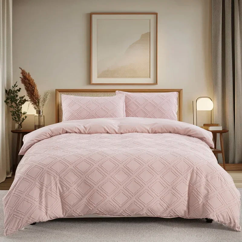 Nutshell modern geometric duvet cover in soft pink with matching pillow shams on a bed