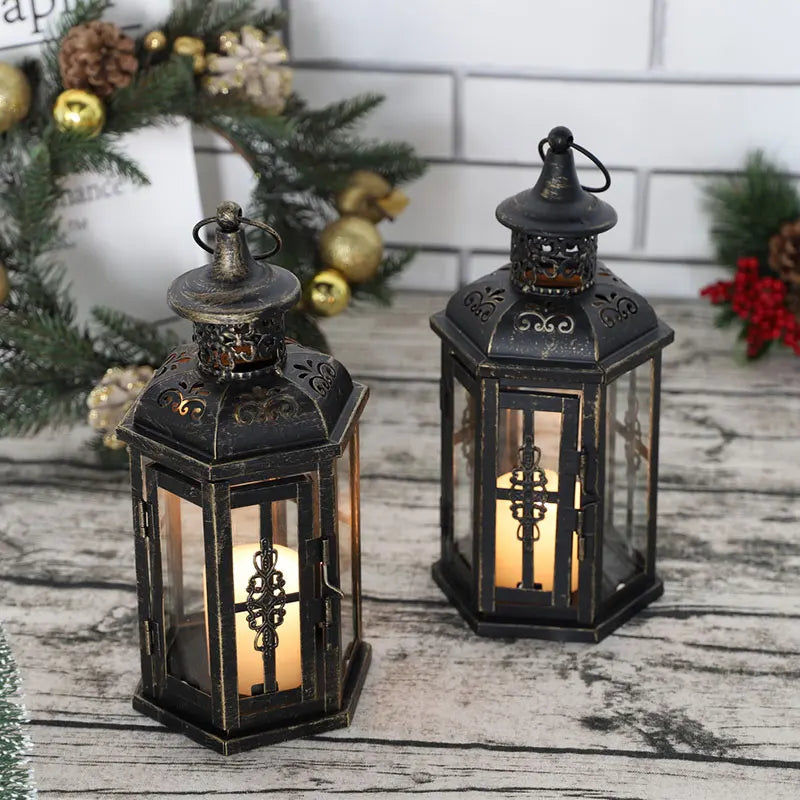 Nutshell vintage candle holder lanterns with intricate metal design and lit candles on rustic wooden table