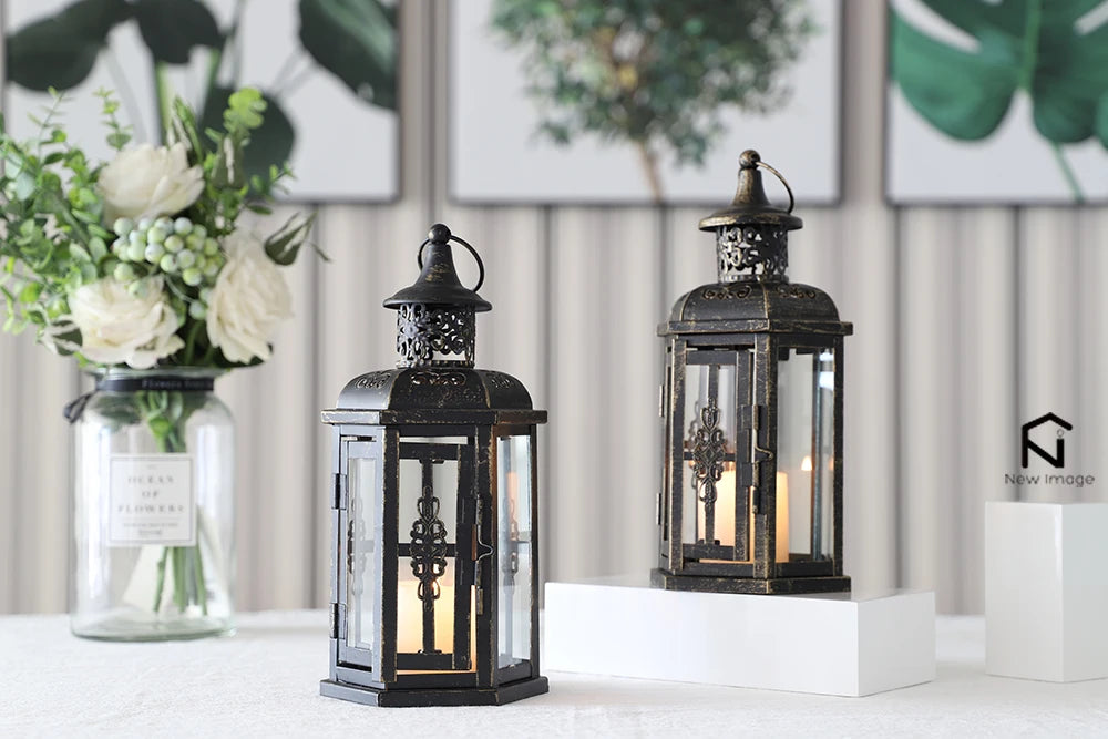 Nutshell vintage candle holder lanterns with intricate metal design and glass panels on white table