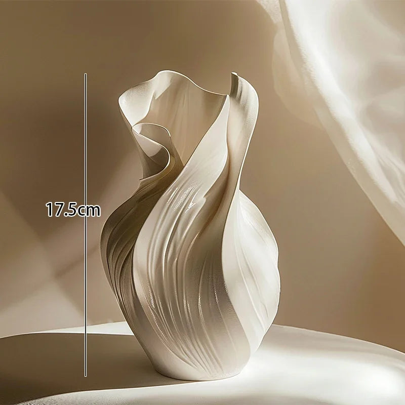 Nordic abstract ceramic vase by Nutshell with flowing sculptural design in creamy white color