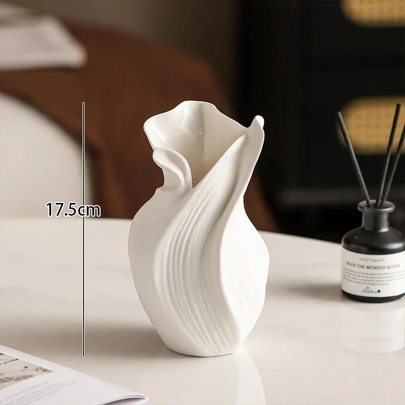 Nordic abstract ceramic vase in white with wavy textured design on a white table