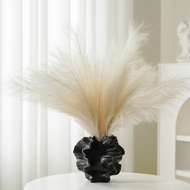 Nordic art coral vase by Nutshell in black with unique wavy design holding decorative pampas grass