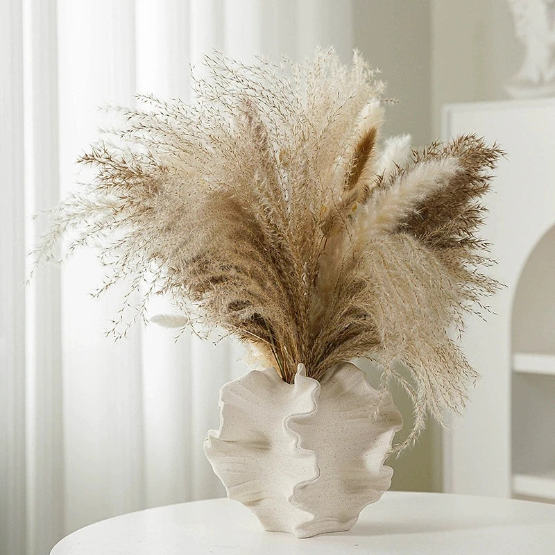 Nordic art coral vase by Nutshell with wavy textured design holding dried pampas grass