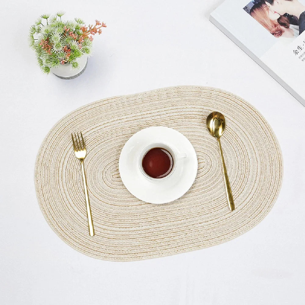 Elegant Oval Braided Placemats in Beige with Gold Cutlery and Coffee Cup on a Table