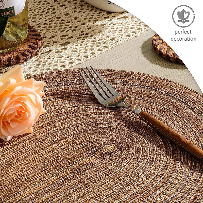 Oval Braided Placemats in natural tones set on a table with a fork and decorative flower